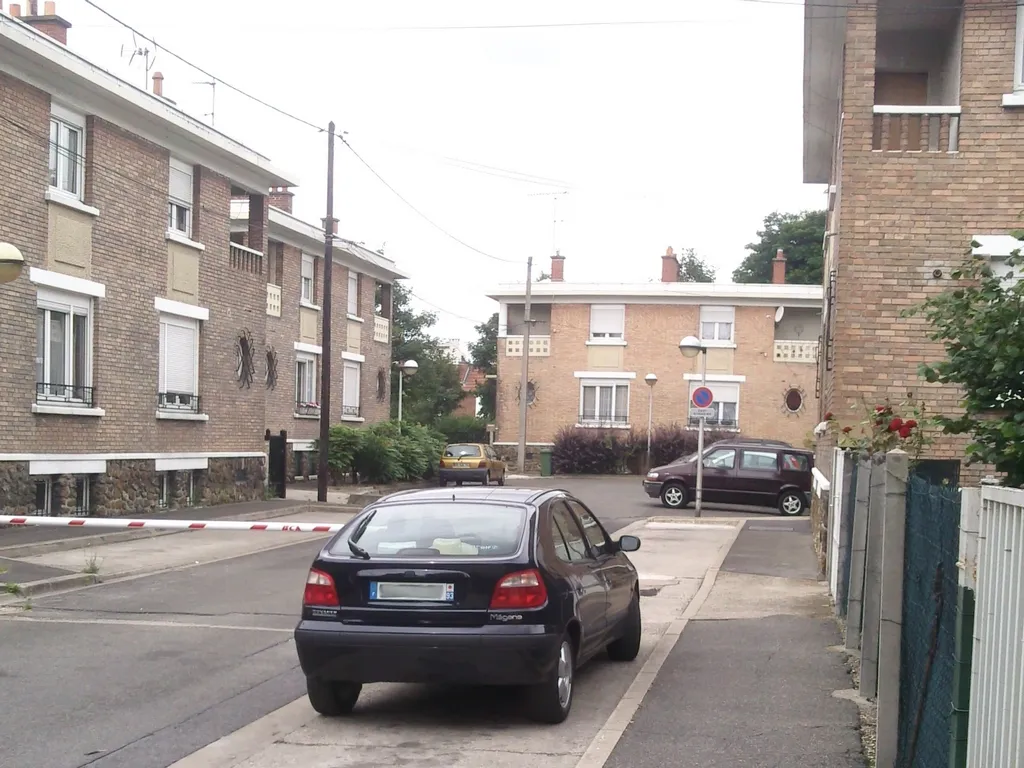 Une maison de la cité-jardin de Drancy, en briques, avec son jardin